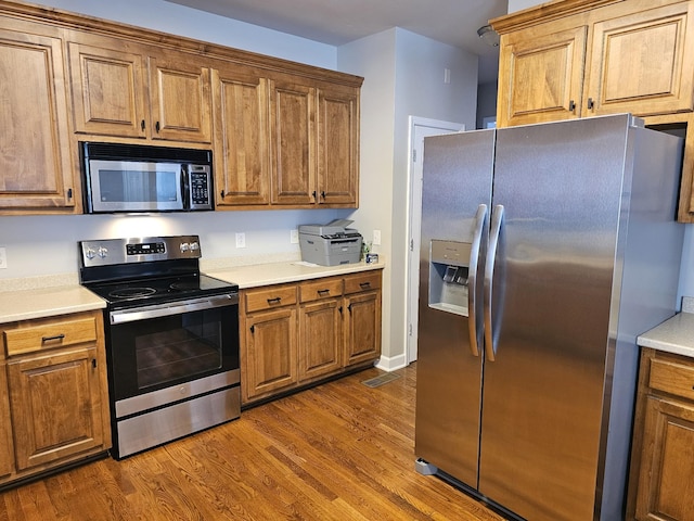 kitchen featuring hardwood / wood-style floors and stainless steel appliances