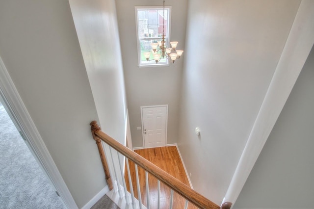 stairs featuring a chandelier