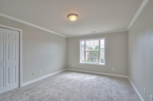 carpeted spare room with ornamental molding