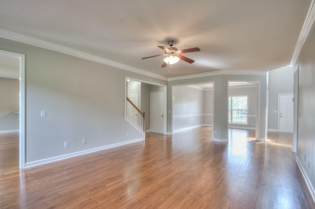 unfurnished room featuring crown molding, ceiling fan, and light wood-type flooring