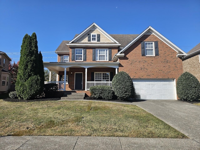 view of front facade featuring covered porch, a garage, and a front yard