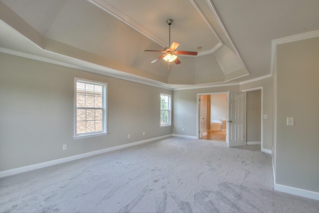 carpeted spare room featuring a raised ceiling, crown molding, ceiling fan, and lofted ceiling