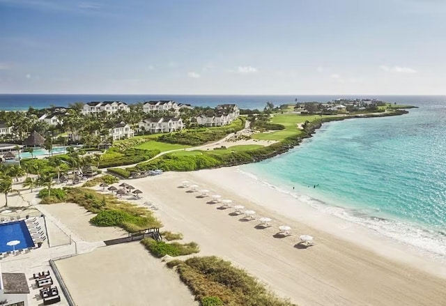 birds eye view of property with a beach view and a water view