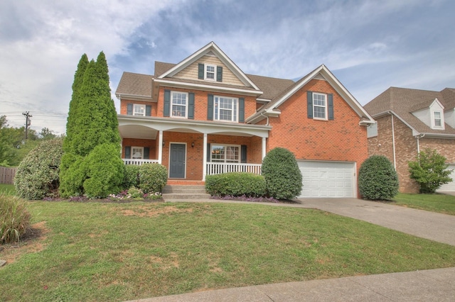 view of front of house with covered porch, a front yard, and a garage