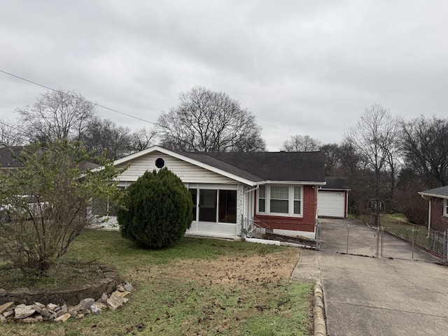 ranch-style home with a garage and a front lawn