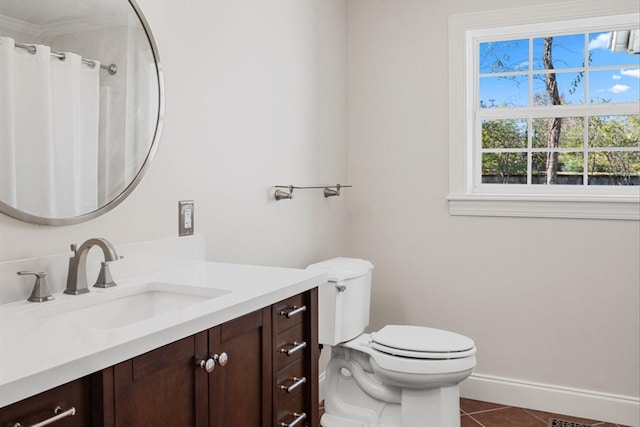 bathroom featuring tile patterned flooring, vanity, and toilet