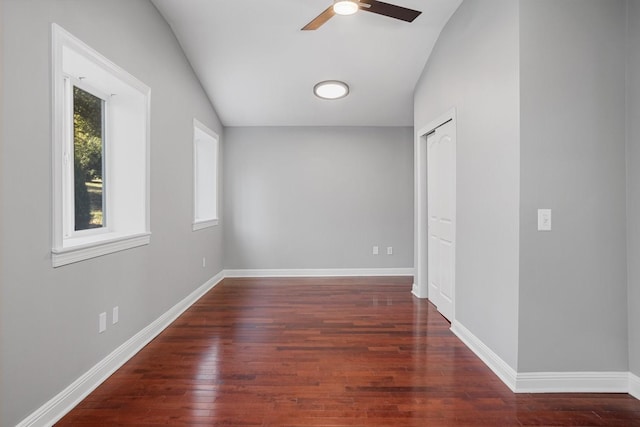 empty room featuring ceiling fan, dark hardwood / wood-style flooring, and lofted ceiling