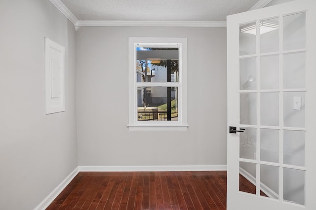 unfurnished room with crown molding, dark wood-type flooring, and a textured ceiling