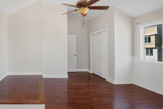 unfurnished room with ceiling fan, dark hardwood / wood-style flooring, and vaulted ceiling