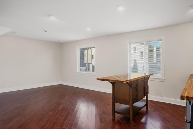 interior space with a wealth of natural light and dark wood-type flooring