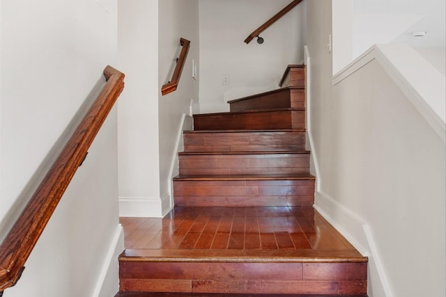 stairs featuring hardwood / wood-style floors