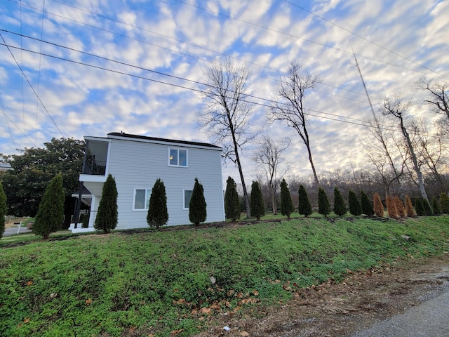 view of side of home featuring a balcony