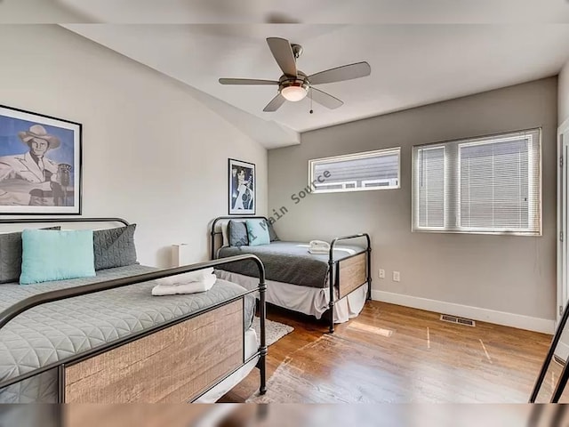 bedroom featuring hardwood / wood-style flooring, ceiling fan, and vaulted ceiling