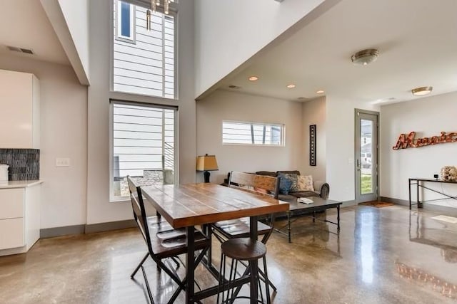 dining room with plenty of natural light and concrete flooring