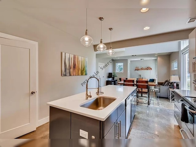 kitchen featuring sink, a healthy amount of sunlight, stove, pendant lighting, and a kitchen island with sink