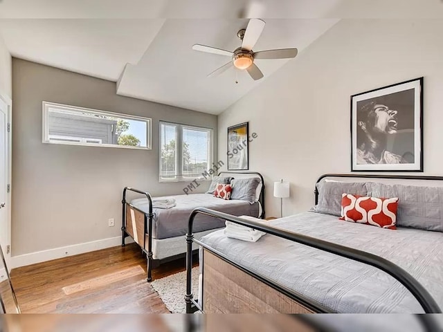 bedroom with light hardwood / wood-style flooring, ceiling fan, and lofted ceiling