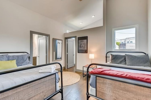 bedroom featuring lofted ceiling and hardwood / wood-style flooring