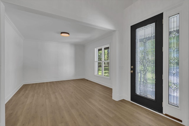 entryway featuring crown molding and light hardwood / wood-style floors