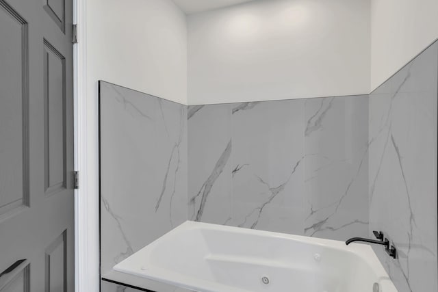 bathroom featuring tiled tub