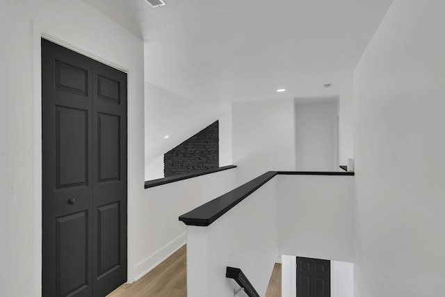 stairway with hardwood / wood-style flooring