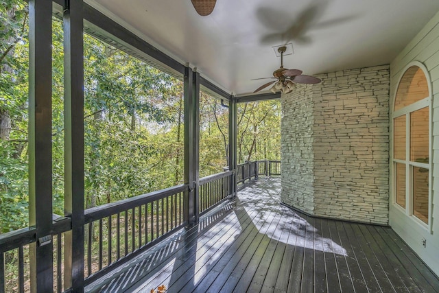 unfurnished sunroom with ceiling fan