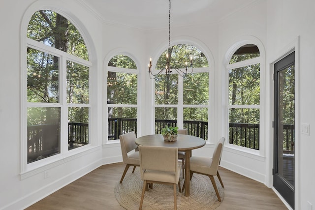 sunroom featuring an inviting chandelier