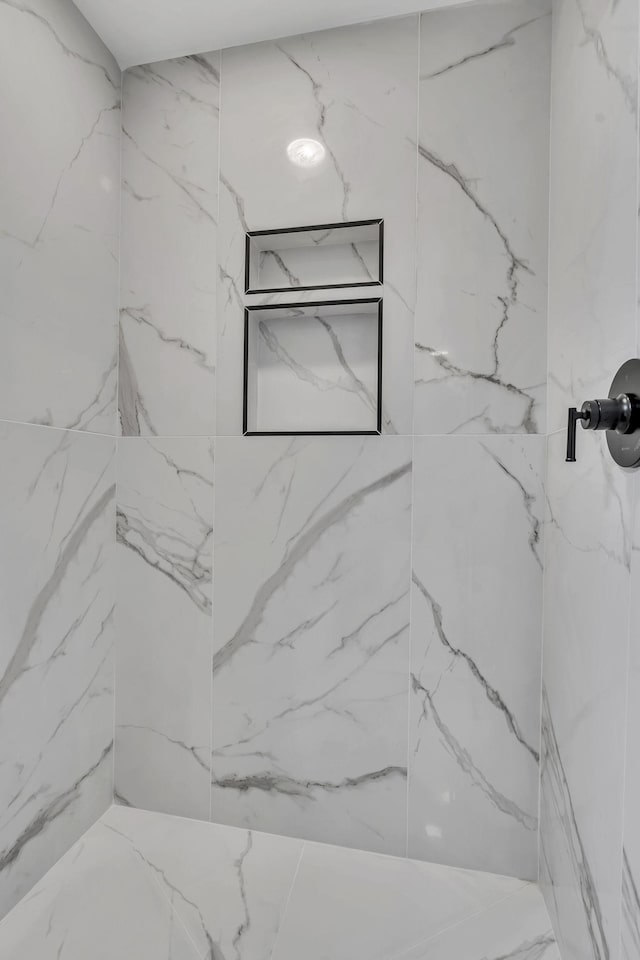 bathroom with a tile shower