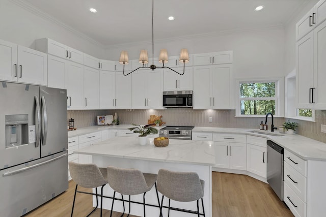 kitchen featuring white cabinets, stainless steel appliances, and a kitchen island