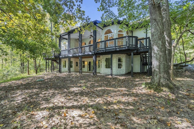 back of property featuring a wooden deck and ceiling fan