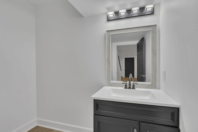 bathroom with hardwood / wood-style floors and vanity