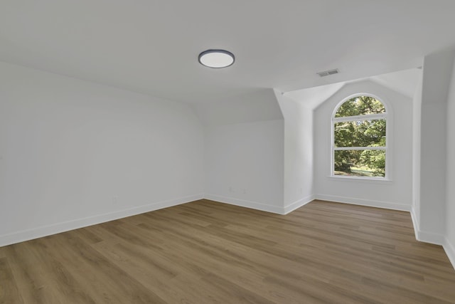 bonus room featuring light hardwood / wood-style flooring and lofted ceiling