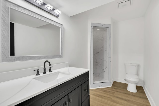 bathroom with vanity, toilet, wood-type flooring, and walk in shower