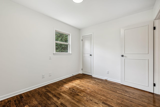 spare room with dark hardwood / wood-style floors