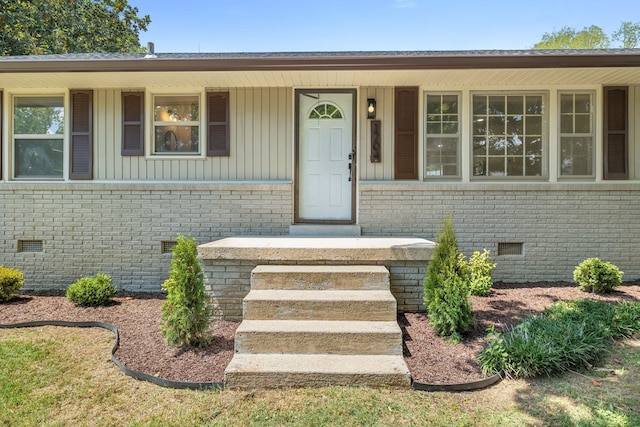 view of exterior entry with a porch