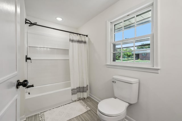 bathroom featuring shower / bath combo, hardwood / wood-style flooring, and toilet