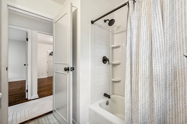 bathroom featuring hardwood / wood-style floors and shower / bath combo with shower curtain