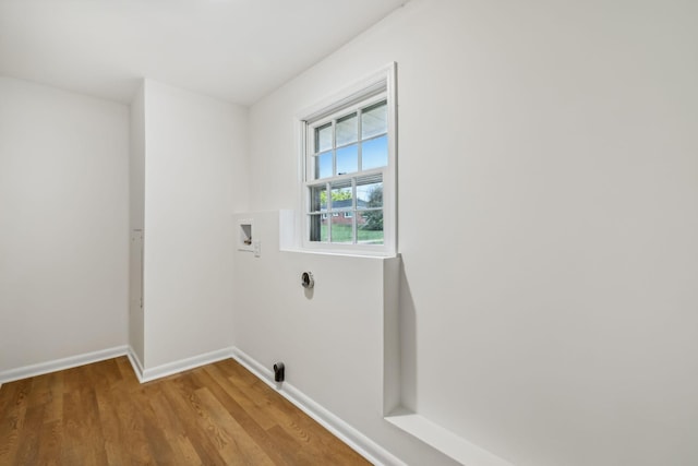 laundry room featuring washer hookup and light wood-type flooring