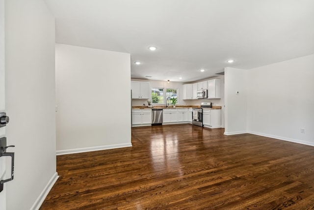 unfurnished living room with dark wood-type flooring