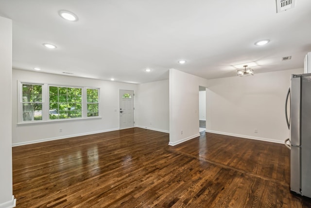 unfurnished living room with dark hardwood / wood-style flooring