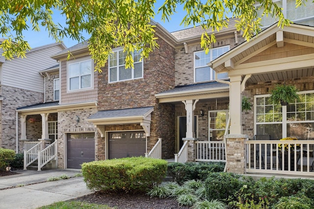 townhome / multi-family property featuring a garage and covered porch