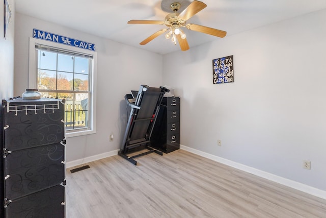 exercise room featuring ceiling fan and light hardwood / wood-style floors