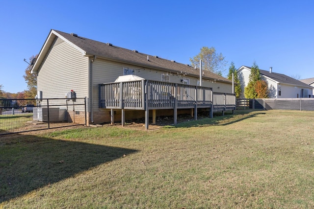 rear view of house featuring a yard and a wooden deck