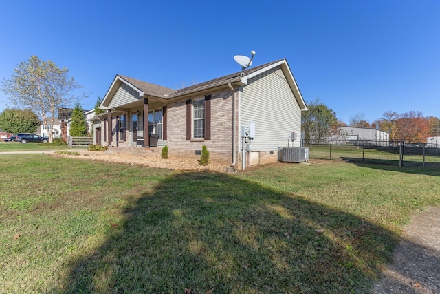 view of home's exterior featuring a lawn, cooling unit, and covered porch