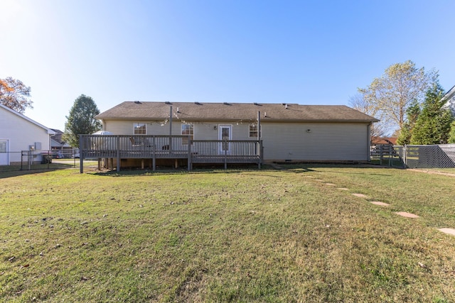 back of house featuring a yard and a deck