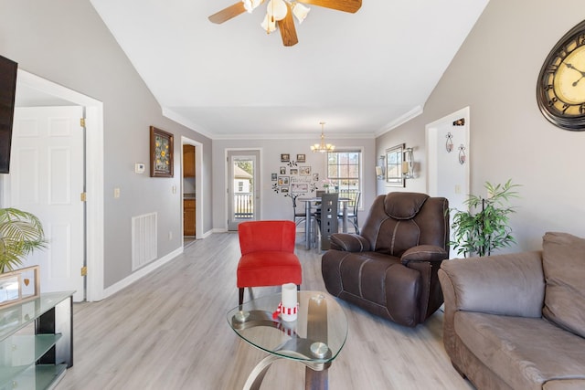 living room featuring lofted ceiling, ornamental molding, ceiling fan with notable chandelier, and light wood-type flooring