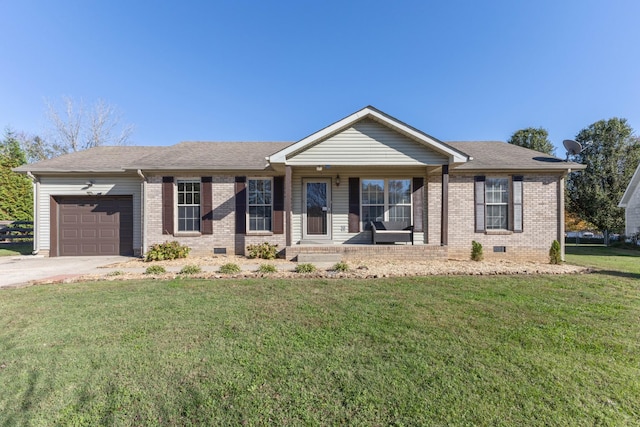 ranch-style home featuring covered porch, a garage, and a front yard