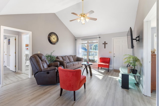 living room with light hardwood / wood-style floors, high vaulted ceiling, and ceiling fan