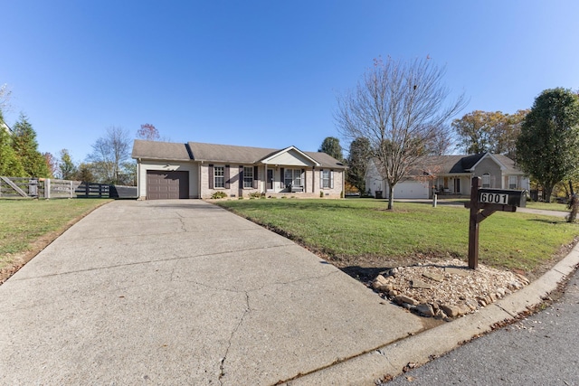 ranch-style home featuring a garage and a front lawn