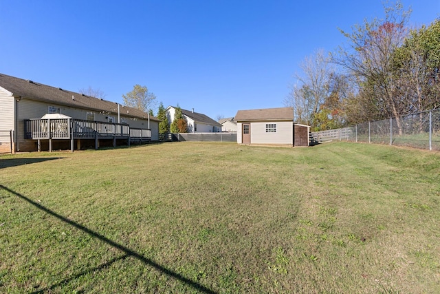 view of yard with a storage shed and a wooden deck