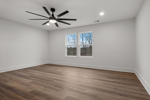 empty room featuring ceiling fan and dark hardwood / wood-style flooring